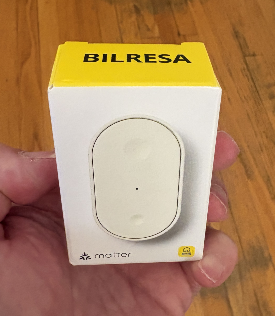 A hand holds a small white and yellow product box labeled "BILRESA" with an oval-shaped device visible through a clear window on the front.