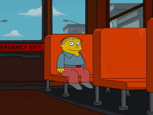 Ralph Wiggum, an animated cartoon character from *The Simpsons*, sits alone on an orange bus seat next to an emergency exit sign, with a city skyline visible through the window.